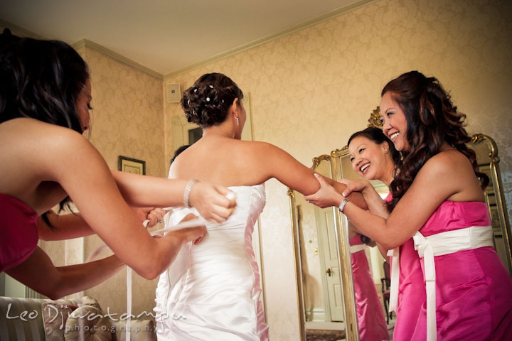 Bridesmaids and maid of honor helping bride getting ready. Ceresville Mansion Frederick Maryland Wedding Photo by wedding photographer Leo Dj Photography